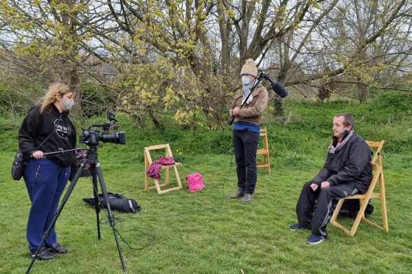 Justin and 2 volunteers learn film-making skills in the park.